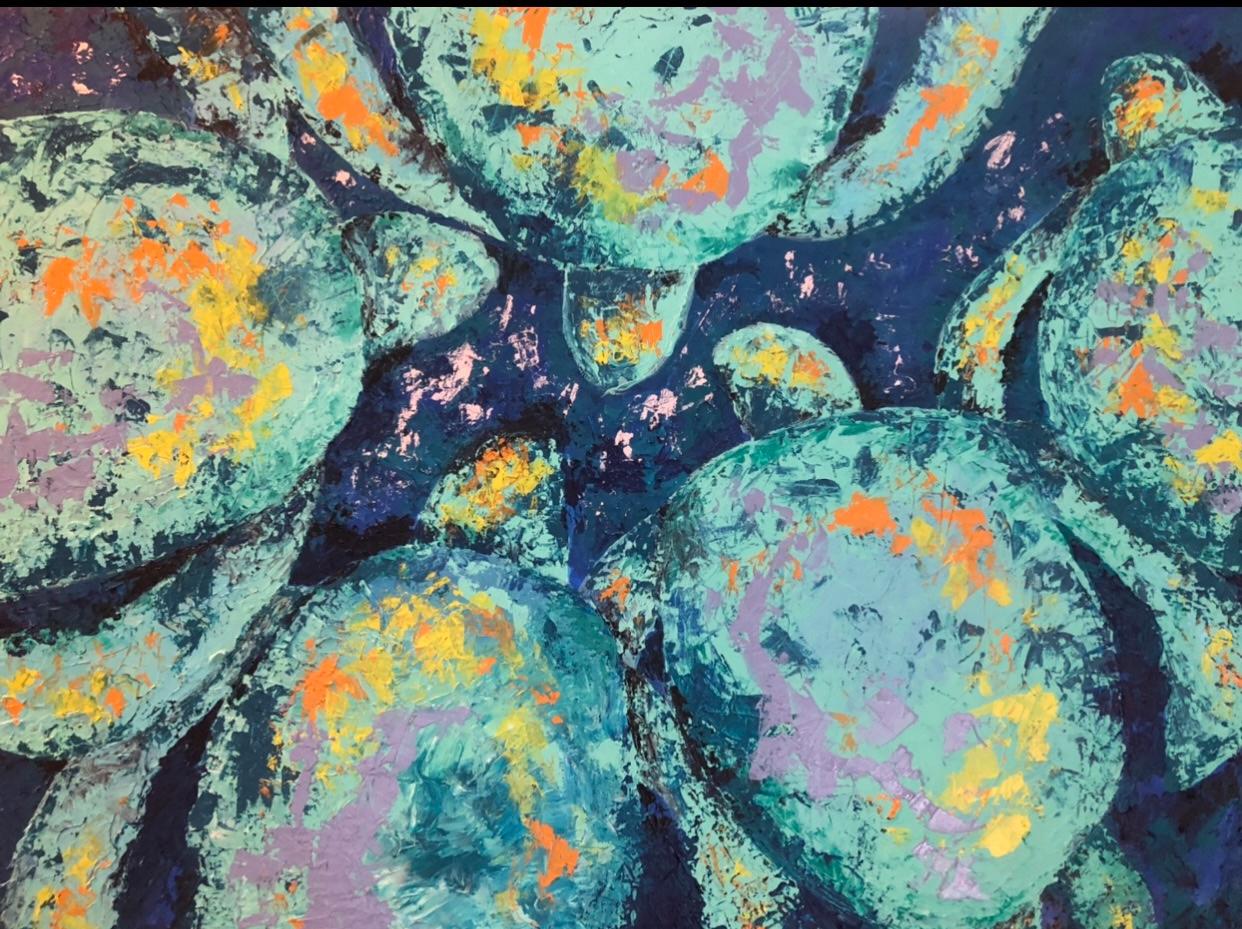 Sea turtle shells packed edge to edge in mint and pale teal, flecked with orange and yellow over deep blue water.
