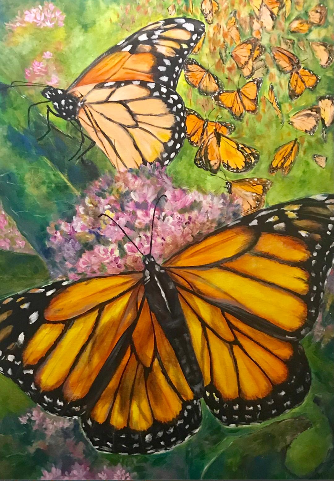 Two monarch butterflies at rest on pink milkweed while a swarm of monarchs scatters across the green field behind.