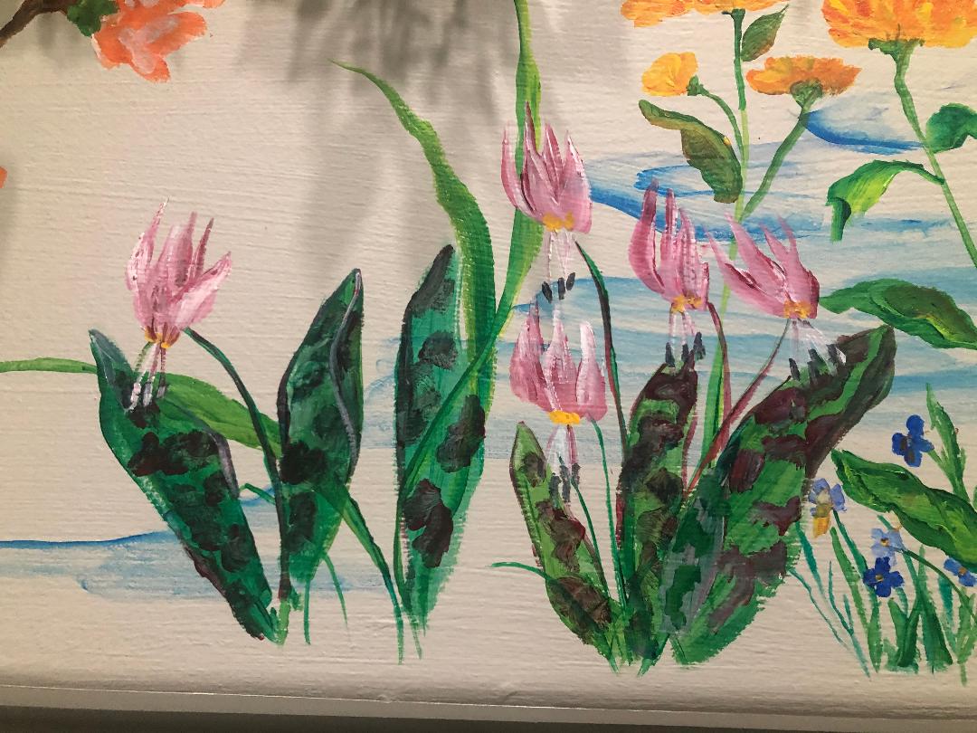 Pink trout lilies, orange blooms and small blue violets painted across a pale wall above a suggested stream.